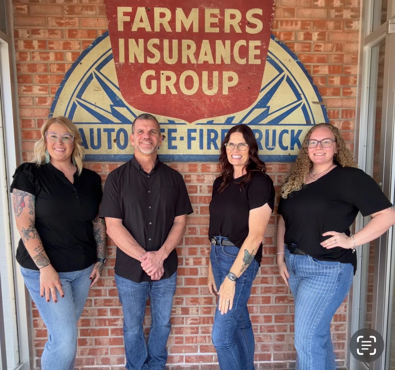 Kent, Viki, Terrance, and Madison together in front of the Farmers Insurance sign